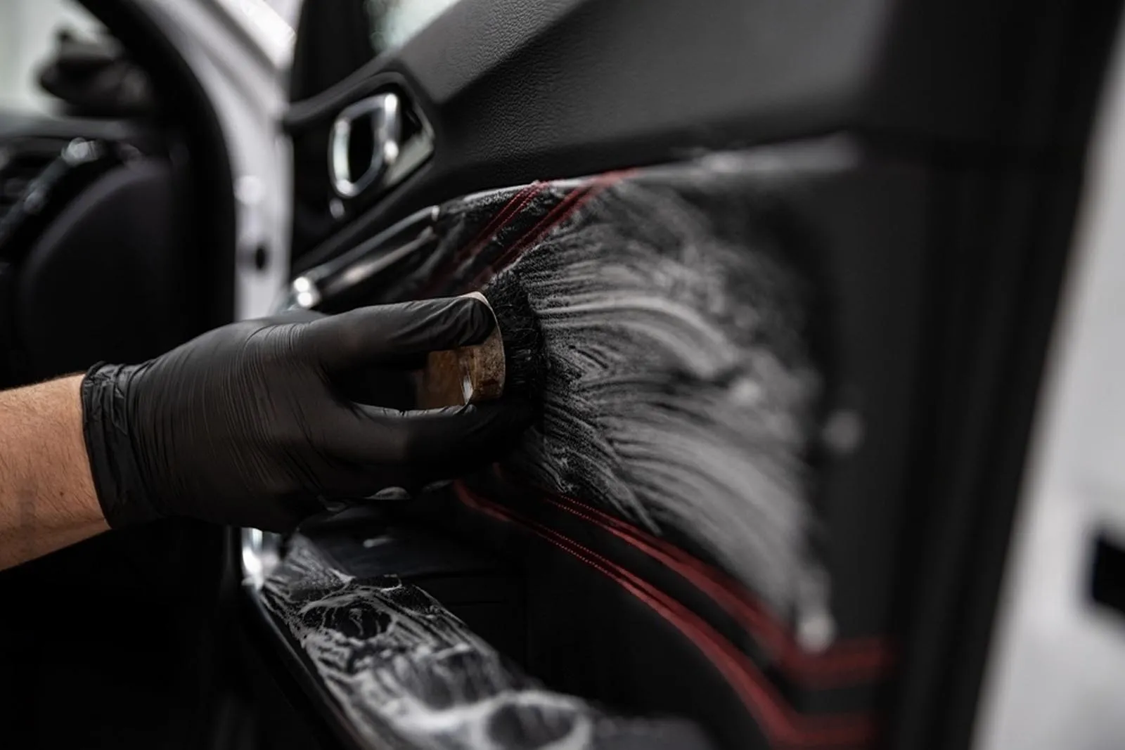 Brush cleaning leather on door panel